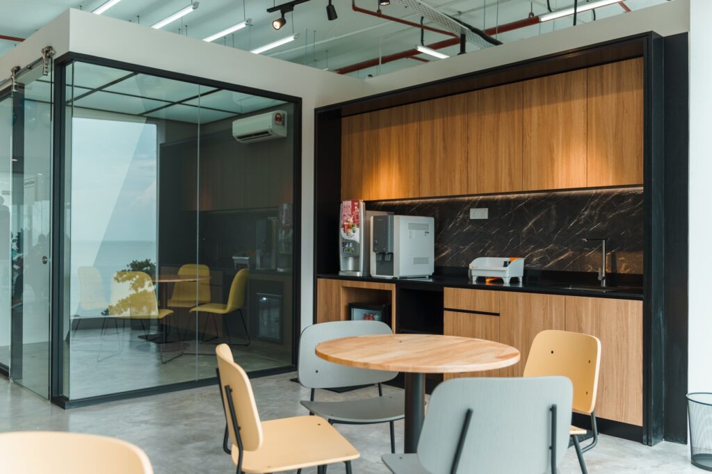 Kitchen pantry at a co-working space with tables and chairs